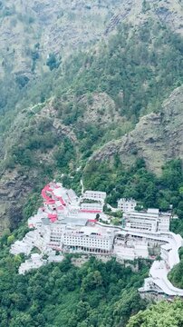 A panoramic featuring the Vaishno Devi Temple complex resting peacefully among the green Himalayan slopes, symbolizing faith, devotion, and natural beauty.