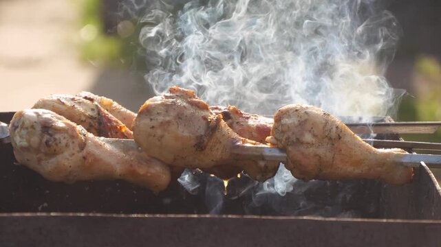 chicken meat is being grilled on the barbecue