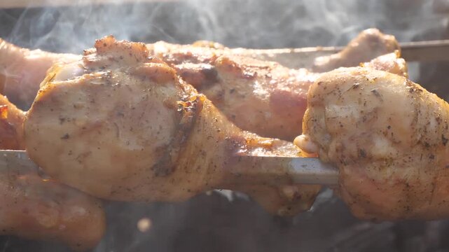 chicken meat is being grilled on the barbecue
