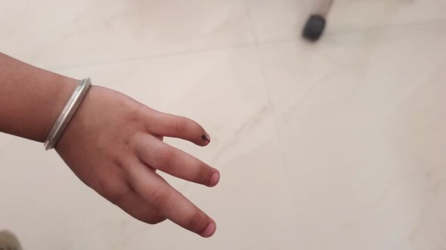 Close-up of a Child's Hand with Polio Vaccination Ink Mark on Finger