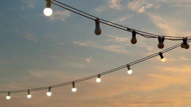 Twinkle String Lights Against a Colorful Blue and Orange Sunset Sky