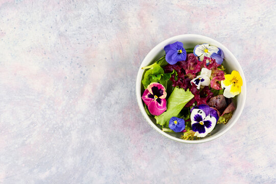 Spring garden salad with edible flowers and mixed lettuce
