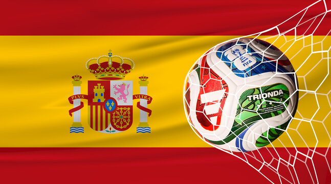 Karachi, Pakistan, 15 July 2026. Football in the net with the flag of Spain. FIFA World Cup 2026. Horizontal Realistic waving flag. Soccer or football tournament. 3d Stock Illustration.