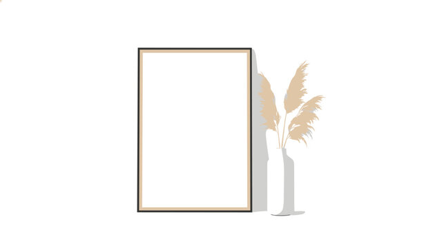 Rectangular blank picture frame is positioned next to a tall white vase containing fluffy pampas grass stems against a clean white wall background.