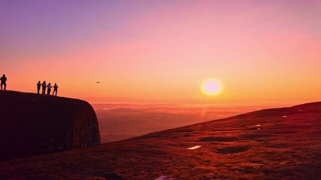 Epic dawn scenery at Hin Sam Wan viewpoint featuring tiny human figures standing atop a colossal sandstone formation surrounded by forests, hills, and morning mist. Three Whale Rock