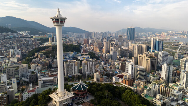 Busan, Busan, South Korea - 26 June 2026: Aerial view of Busan Tower surrounded by the dense urban landscape, high-rise buildings, and hills.