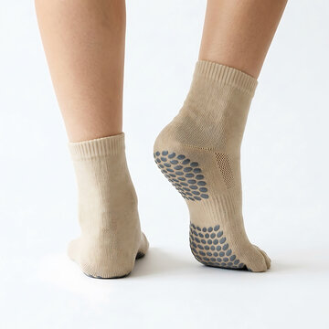 Beige toe socks with black polka dots on feet