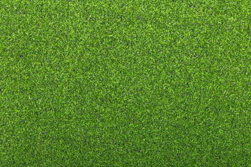 Artificial soccer turf texture with dense green synthetic grass blades in close up view. Sports background for soccer field, training ground, playground, and outdoor design. © natrot