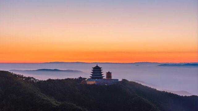 Pagoda Structures and Ancient Mountain Monastery Nestled Amidst Lush Green Hills and a Foggy Valley at Vibrant Sunrise.
