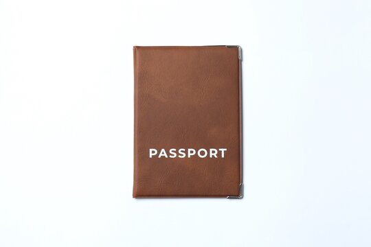 Passport in a brown cover on white background, top view.