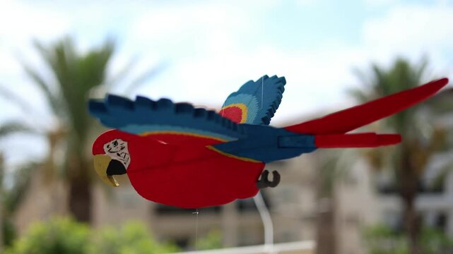 Handmade mechanical wooden bird automaton moving on a white background