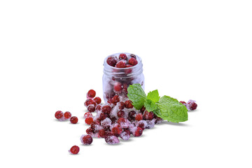 Frozen red currants with ice crystals in a glass jar isolated on white background. Ripe frozen berries with mint leaf and copy space. © Светлана Кушнир