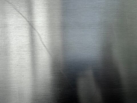 Close-up of perforated stainless steel surface with industrial metal texture. Modern metallic background suitable for engineering, manufacturing, technology, and design applications.