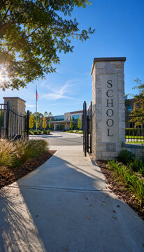 School entrance with well-maintained pathway and flag