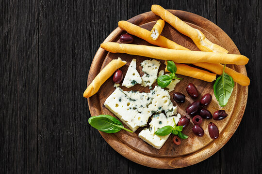 Premium blue cheese board with grissini and olives
