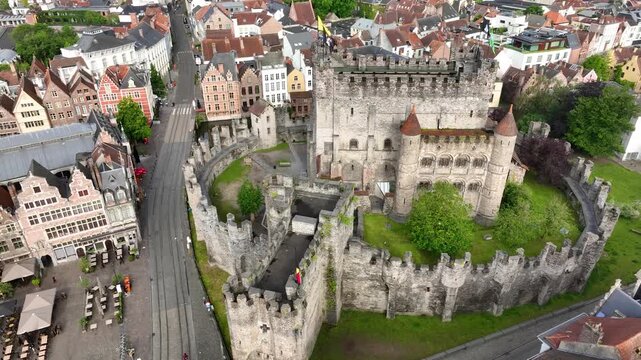 Aerial drone view of Ghent old town in Belgium, with the towers of St. Nicholas and St. Michael's Churches and Castle of the Counts next to river Lys. Architecture and landmarks of the medieval city.