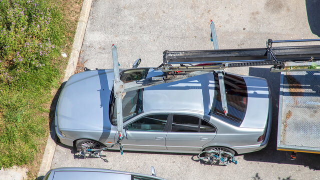 Car Transporter Loading a Silver Sedan on Vehicle Carrier Truck