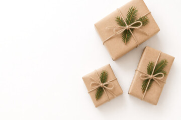 Minimalist Christmas gift boxes wrapped in natural kraft paper with twine.