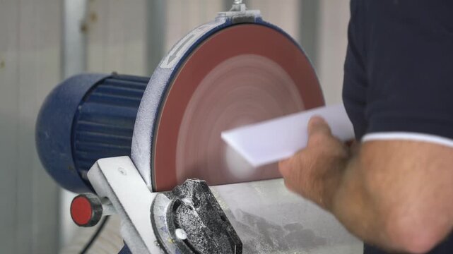 Industrial Grinding Wheel Polishing Stone Surface with High-Speed Abrasive Disc in Manufacturing Workshop