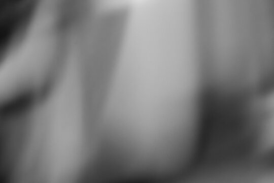 Abstract blurred background with soft monochrome gradients. Black and white out-of-focus bokeh texture with elegant smooth shadows.