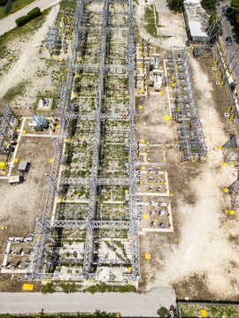 Aerial view of CFE SE Norte electrical substation with metal structures, high-voltage equipment, and transformers on gravel ground in Merida, Yucatan, Mexico.