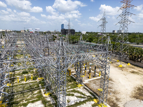 Aerial view of the CFE SE Norte electrical substation featuring complex steel lattice structures, power lines, and electrical equipment in Merida, Yucatan, Mexico.