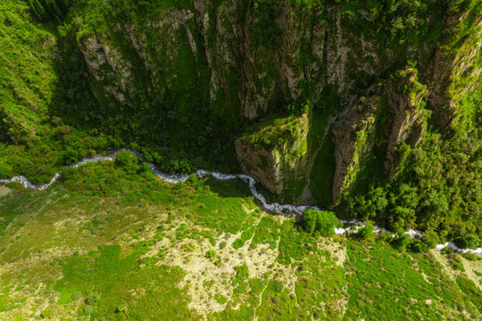 Aerial View of a River Winding Through a Green Gorge