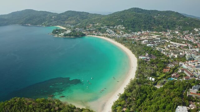Tropical island landscape, Patong Beach and Phuket town, Thailand. White sand, lush green hills and crystal clear turquoise ocean waters. Perfect for travel and vacation concept. Aerial view panorama