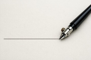 Fototapeta premium A pen sits atop a blank piece of paper, ready for writing or drawing