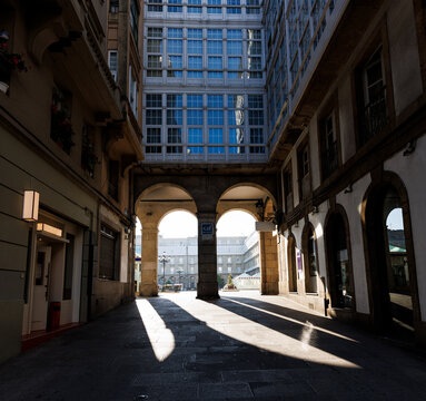 Looking through the arcades of Maria Pita Square in La Coruna, Spain.