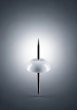 A simple white plastic pushpin, or thumbtack, shown in close-up detail against a plain neutral background, organization, point, affix