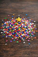 Fototapeta premium Colorful confetti sprinkles spread across a wooden table, perfect for celebrations and parties