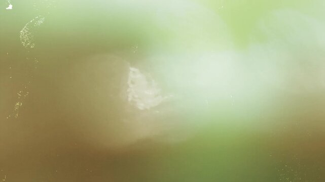 Chemical damaged celluloid light leak video transition. Vintage abstract burnt orange light leak footage for alternative rock music videos.