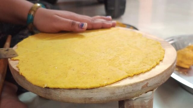 Close up of Preparing Homemade Gujarati Dhokli Snack on Wooden Chakla