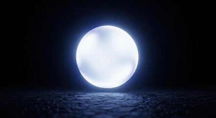 Obraz premium A bright luminous sphere floats above a textured surface in darkness, representing a moment of creative thought and invention, motivation, idea, shadow