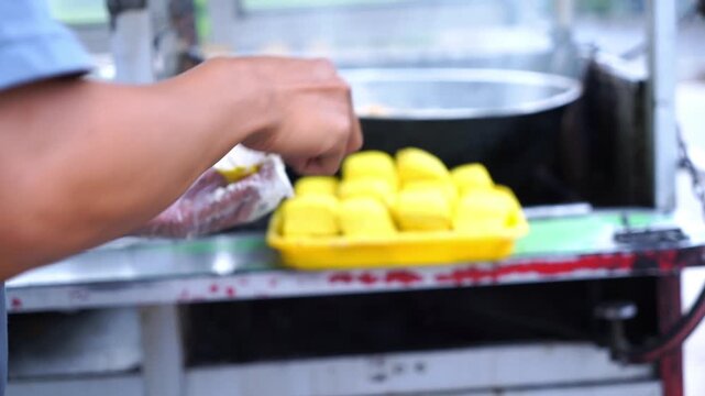 Street Food Preparation
aptures the authentic process of cooking, fresh dough batter, and ready-to-serve fried snacks in a casual outdoor setting.