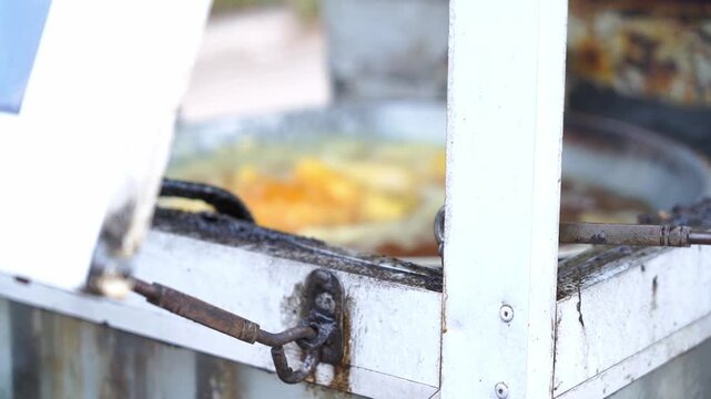 Street Food Preparation
aptures the authentic process of cooking, fresh dough batter, and ready-to-serve fried snacks in a casual outdoor setting.