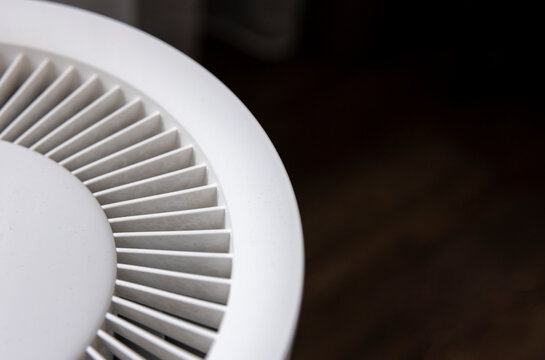 Close-up of details of a white, futuristic, and minimalist room humidifier.
