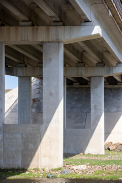 concrete columns supporting the bridge over the river
