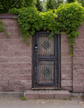 brick fence with a gate for entry into a private, enclosed area
