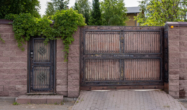 brick fence with a gate for entry into a private, enclosed area
