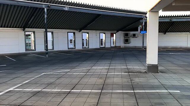 An empty covered parking lot.