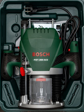 Brand new Bosch POF 1400 ACE electric router machine packed neatly inside its original green plastic carrying case ready for woodworking projects