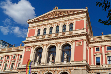 Fototapeta premium The Neoclassical Musikverein Building in Vienna Featuring Classical Statues and a Symbolic Pride Flag