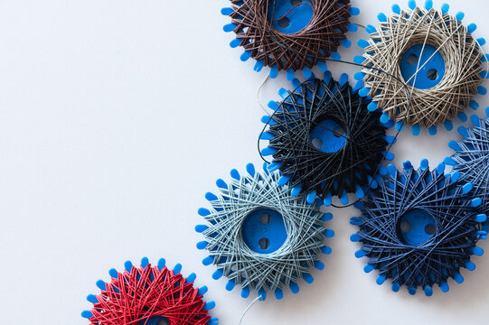six spools of sewing thread and darning thread in different designs and colors