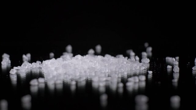 Slow Motion Falling Salt Crystals on Black Background