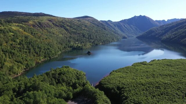 4K aerial drone footage of Coldwater Lake near Mount Saint Helens in Washington, USA. Scenic Pacific Northwest summer landscape with volcanic mountains, evergreen forest and pristine freshwater