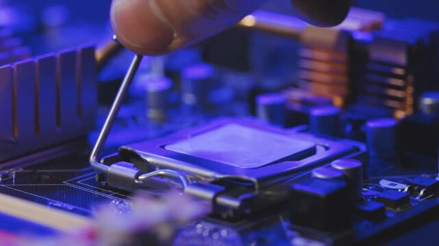 Technician Installing Computer Processor on Motherboard