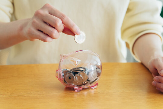 貯金する若い女性の手元
