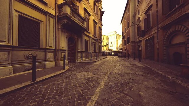 lantern lit romantic cobblestone street at dusk with warm caf awning and empty tables, reflective puddles and intimate atmosphere ideal for lifestyle